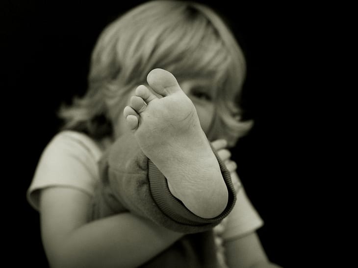 child holding up foot